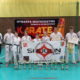 na zdjęciach turniej karate w hali sportowej i wręczenie nagród na podium