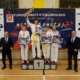 na zdjęciach turniej karate w hali sportowej i wręczenie nagród na podium