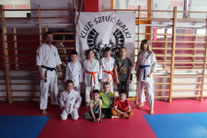 na zdjęciu uczestnicy zajęć karate w sali gimnastyczne w zdjęciu grupowym