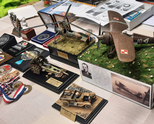 na zdjęciu modele samolotów i medale na stole
