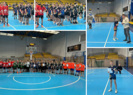 Drużynowe zdjęcie młodych zawodników w hali sportowej, prezentujących zdobyty puchar i dyplom wraz z trenerami po zakończonych rozgrywkach.
