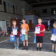 Galeria zdjęć przedstawiająca modele samolotów na trawiastym terenie. Widoczne są ujęcia z lotu ptaka, uczestnicy wydarzenia, przygotowane modele oraz moment wręczania nagród.